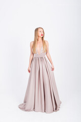 young girl in a wedding dress on a white background