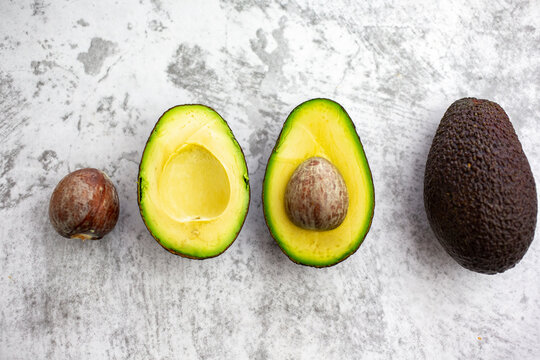 Studio shot of seed, halves and whole avocado