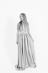 Naklejka premium young girl in a wedding dress on a white background