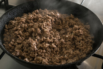 Close-up of minced meat in the pan. Prepared for spaghetti Bolognese