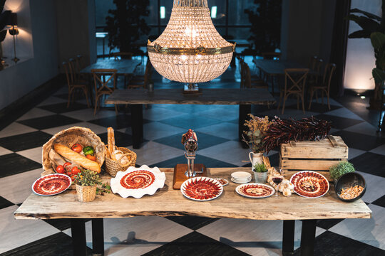 Meat arranged in pattern on plate over restaurant table