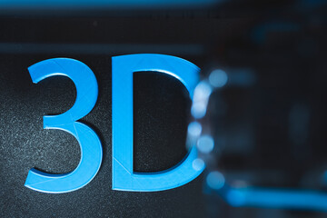 Blue 3D text on black printer