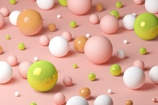 Three dimensional pattern of various spheres flat laid against pink background