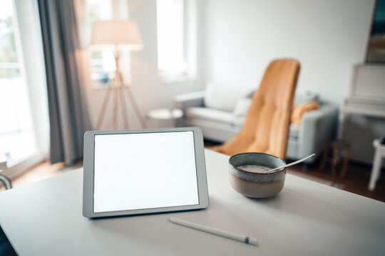 Digital tablet with food on table at home