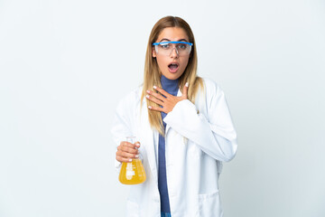 Young scientific woman isolated on white background surprised and shocked while looking right