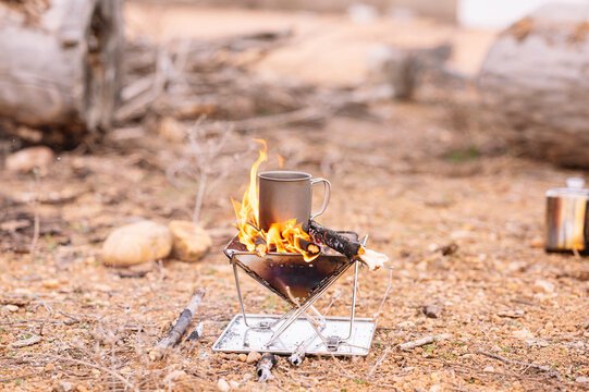 Mug on wood burning stove at ground