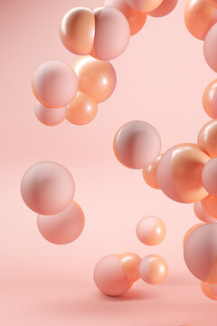 Three dimensional render of pink and orange spheres floating against pink background