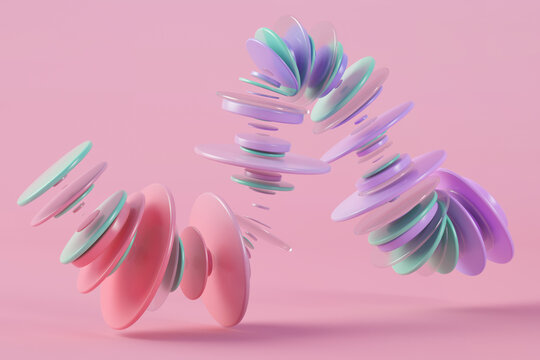 Three dimensional render of pastel colored rings floating against pink background