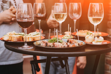 Wine and food served for a friendly party.