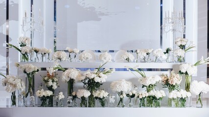 Romantic Wedding Table Top Layout Decor with large lush floral bouquets including white roses, ranunculus, persian buttercups, white orchids and candles