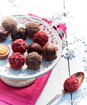 Plate of pralines on table with Christmas decor