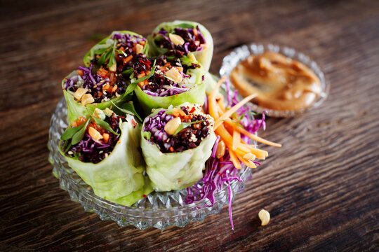 Cabbage rolls with black rice, sesame seeds, carrot and red cabbage
