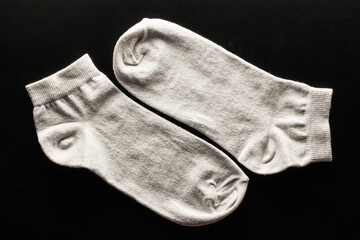 Pair of white socks on black background