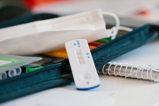 Coronavirus protective face mask with test kit on desk
