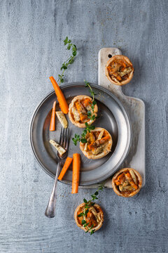 Pie with carrots and parsnip on tin plate
