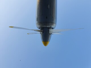 Airplane propeller against the blue sky. The aircraft engine is muted.