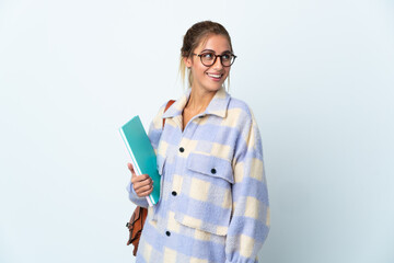 Young student woman isolated on white background looking to the side and smiling