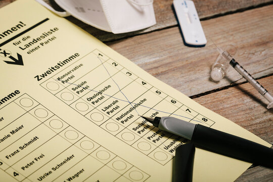 Ballot and pen on table with protective mask and corona rapid test
