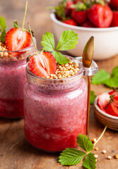 Strawberry chia pudding in glass jars.