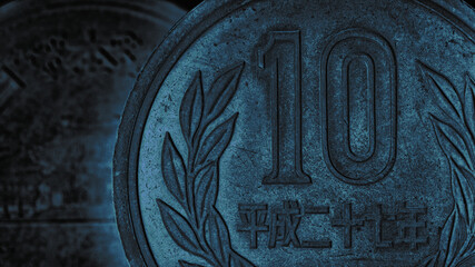 Translation: Japan 2015. Japanese coin of 10 yen close-up. Dark blue tinted background or wallpaper. Backdrop about money, economy, finance and taxes in Japan. Macro