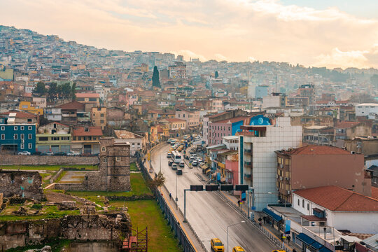 Vehicles on street amidst buildings and The Ancient Agora in Konak during sunset, Smyrna, Izmir, Turkey