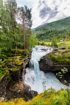 Water flowing through rocks by trees, Gudbrandsjuvet, Norway