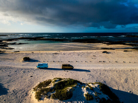 Aerial view of camping vans on sand track in Fuerteventura