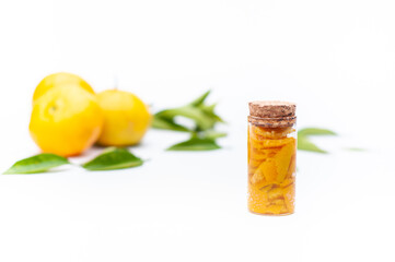 Glass jars of mandarin essences oil, isolated on white background