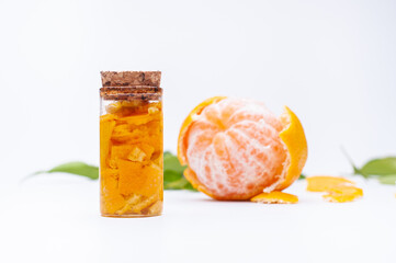 mandarin essences processing, isolated on white background and with mandarins in the background out of focus.