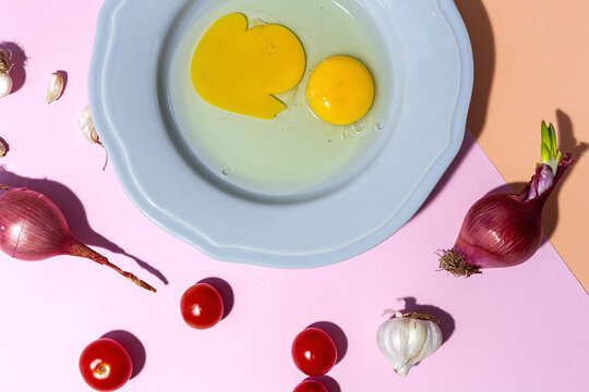 Fresh eggs on plate against ripe cherry tomatoes