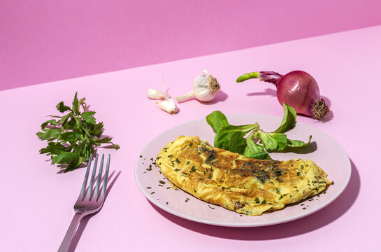 Delicious omelet with fresh spinach leaves and chopped parsley