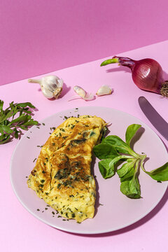 Delicious omelet with fresh spinach leaves and chopped parsley