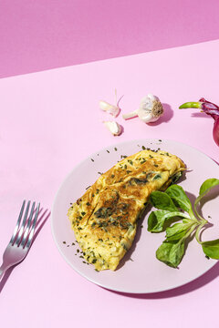 Delicious omelet with fresh spinach leaves and chopped parsley