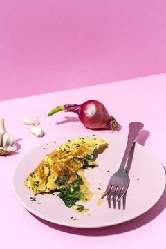 Delicious omelet with fresh spinach leaves and chopped parsley