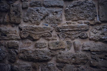 Closeup shot of engravings and symbols in an ancient stone wall