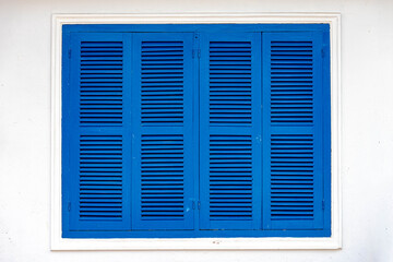 Fototapeta premium Outdoor vintage blue colour window with white cement, Wooden louver window with concrete wall. 