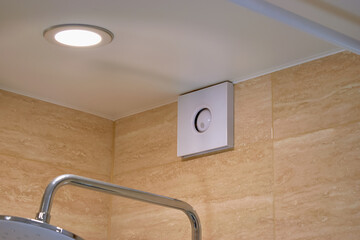 Electric extractor hood in the bathroom. Electric exhaust fan. Ventilation of the air in the...