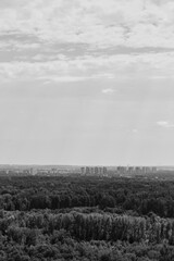 view from a high floor to a new residential district surrounded by a forested area. summer image. Concept of cityscape photography. selective focus 