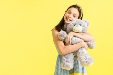 Adorable young girl playing with her toys