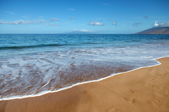 Beach background. Calm beautiful ocean wave on sandy beach. Sea view from tropical sea beach. © Volodymyr