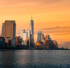 city skyline at sunset Manhattan New York panorama travel sea urban buildings sky color orange 