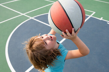 Portrait of little boy play basketball. Concept of kids sports.
