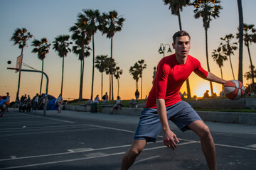 Basketball player dribbling the ball between his legs.