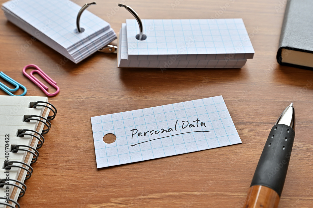 Poster there is a word book with the word privacy data written on it with a pen and notebook.
