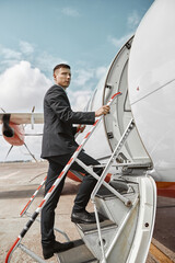 Flight attendant going up on ladder to airplane