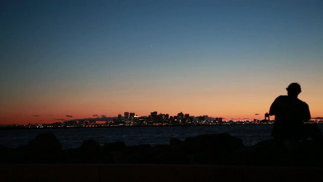 boston skyline airport silhouette man harbor