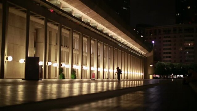 girl walks along plaza boston night