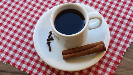 Delicious mulled wine with ginger, cloves and cinnamon in a cup on the table. Typical hot drink for June in Brazil. June celebration. Brazilian June Party.