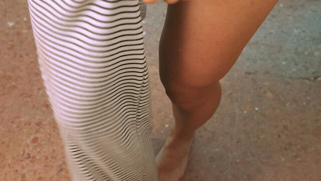 summer, beach - young woman gets dressed after a day at the beach