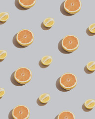 Fresh orange grapefruit and lemon patttern on sandy grey background. Citrus pattern.